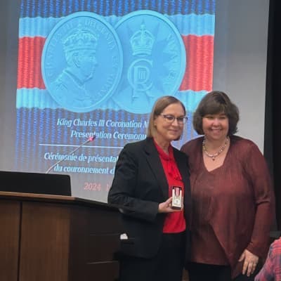 Dr. Karen Somerville receiving coronation medal