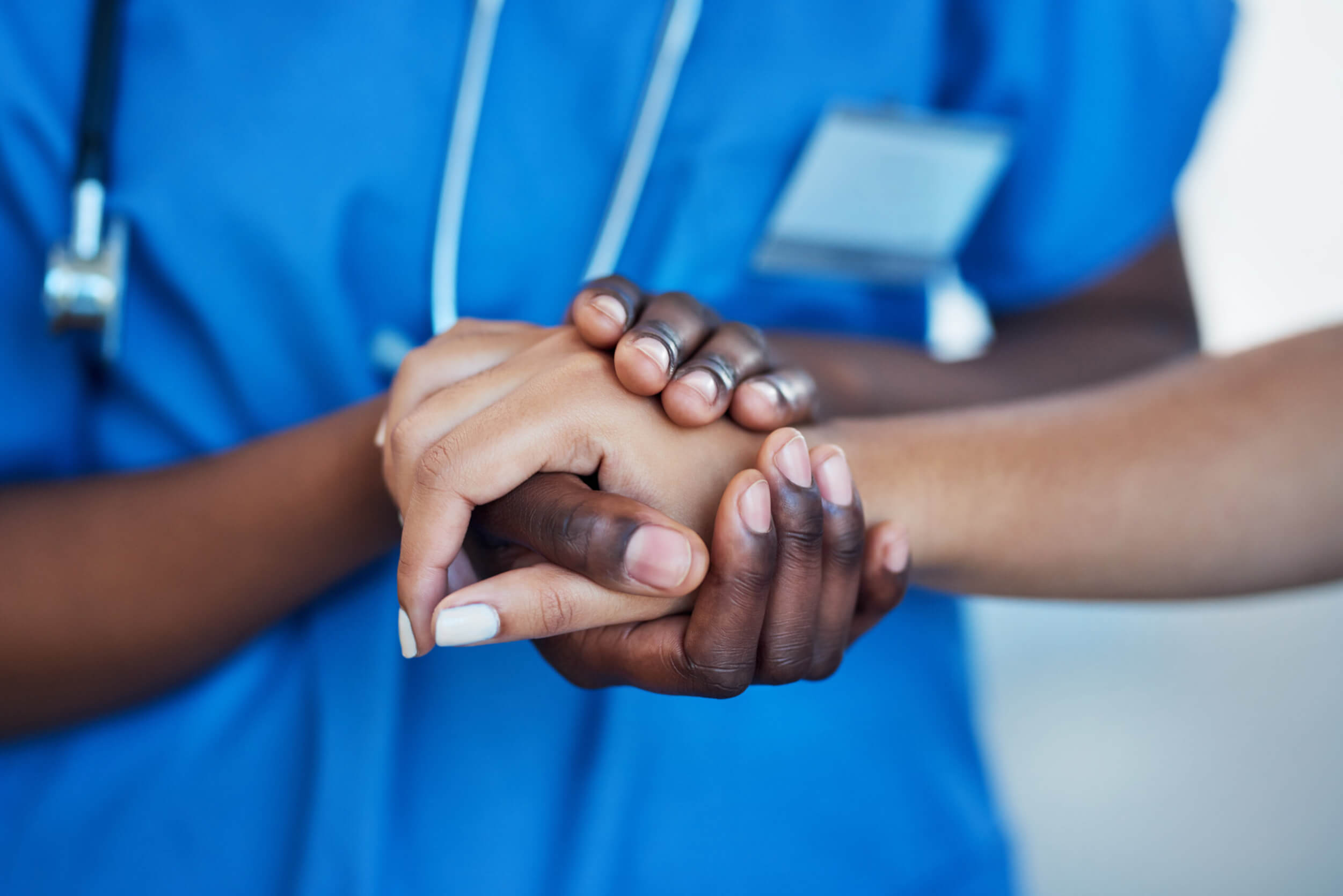 Closeup shot of a nurse holding a patient's hand in comfort