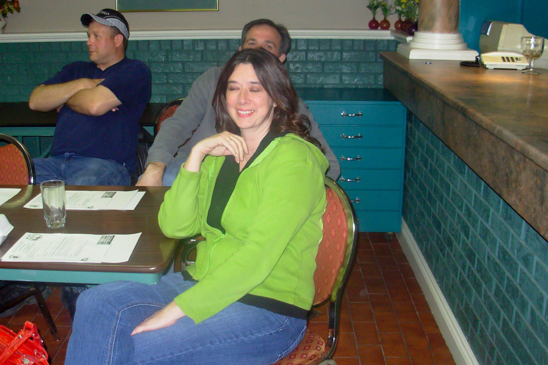 Athabasca University grad and traumatic brain injury survivor Kimberley Melbourne seated at a restaurant table