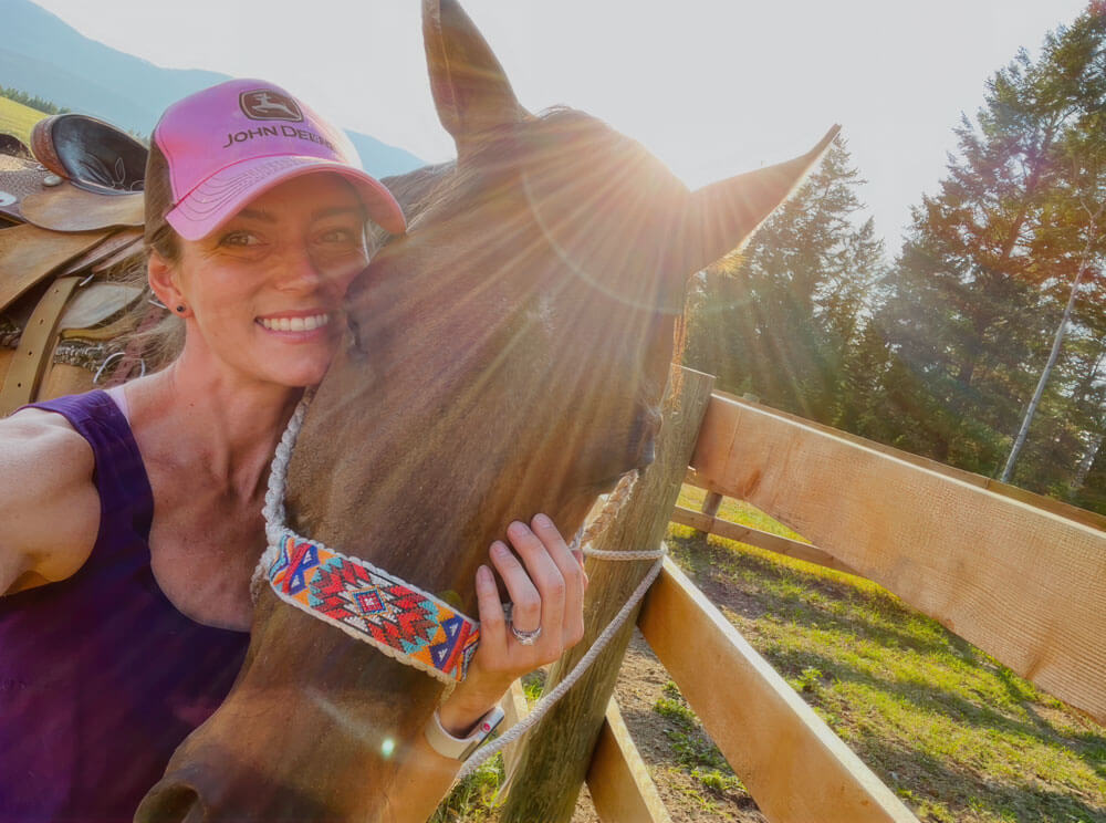 Linea Xaysana embraces a horse at sunset