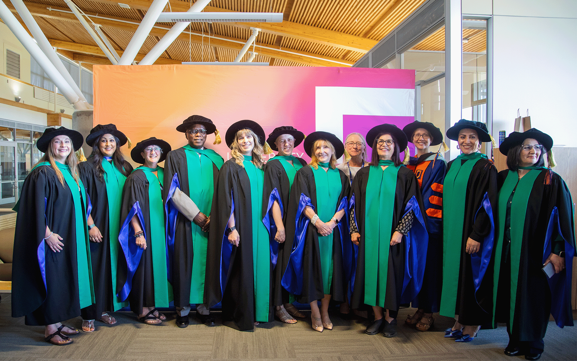 Group of Doctor of Education in Distance Education graduates dressed in their academic regalia