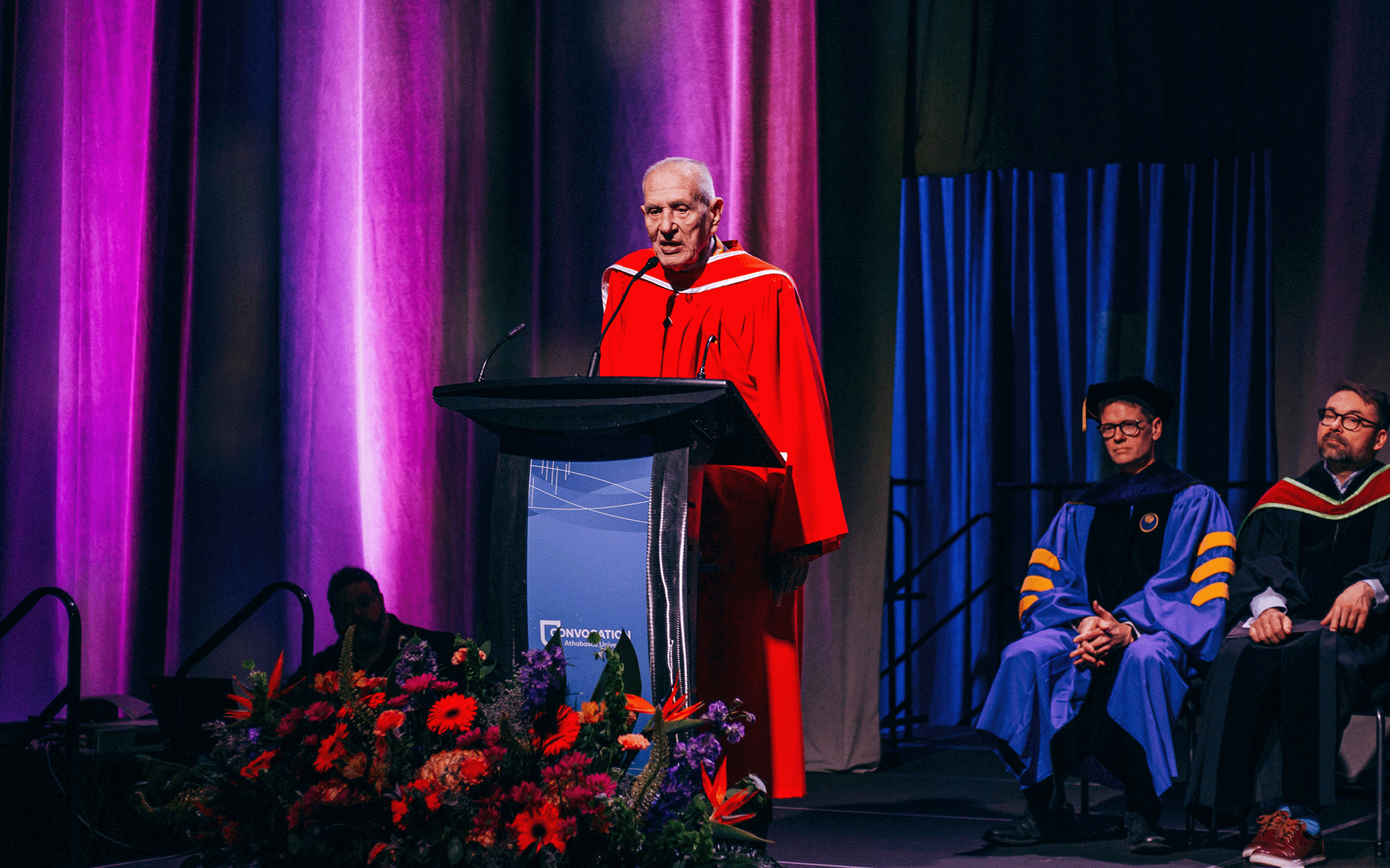 Douglas J. Cardinal receiving Honorary Doctor of Laws, image is focused on older man standing at the podium