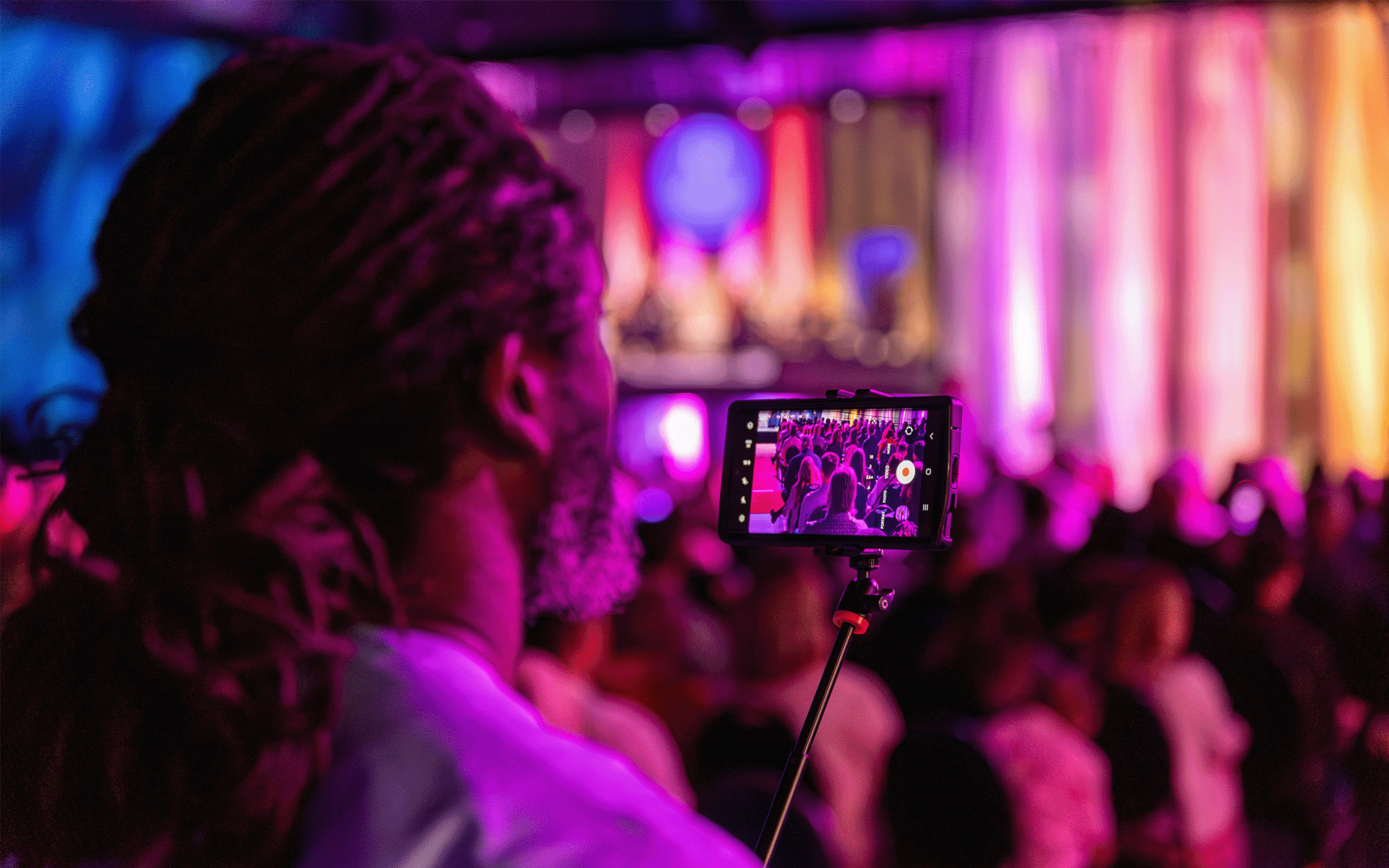 Person watching the ceremony and recording on their phone