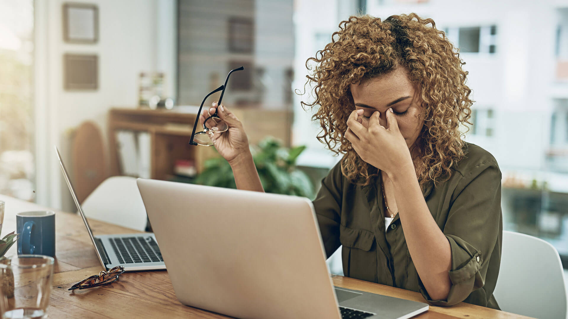 woman appears exasperated in front of computer