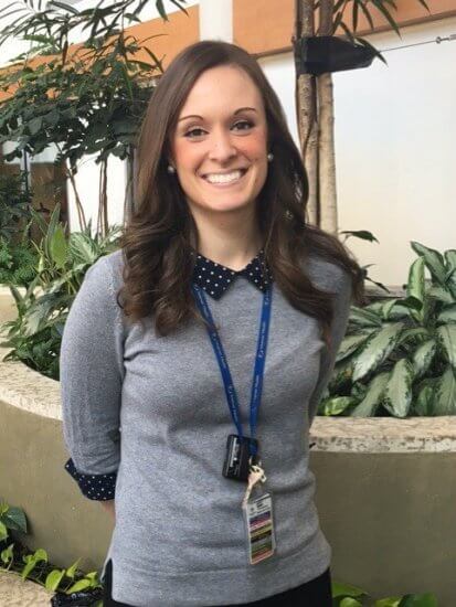 Brittany Hollett smiling and wearing grey sweater