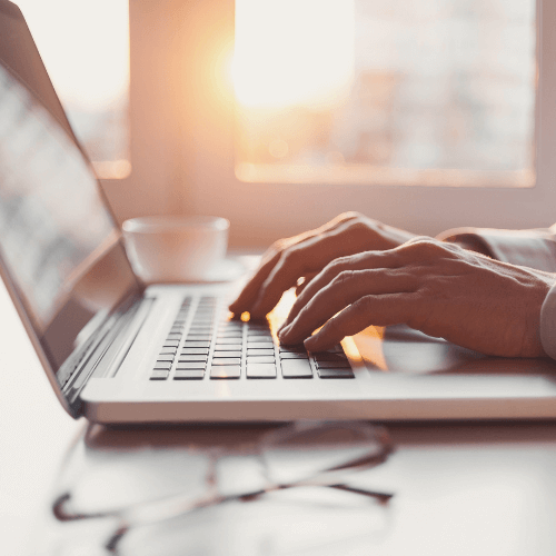 person typing on a laptop