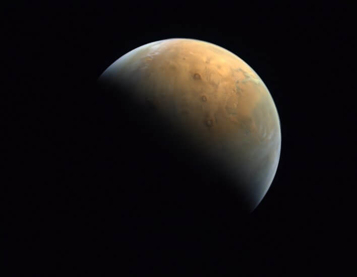 a crisp picture of a planet (Mars) with red hues in front of a black sky