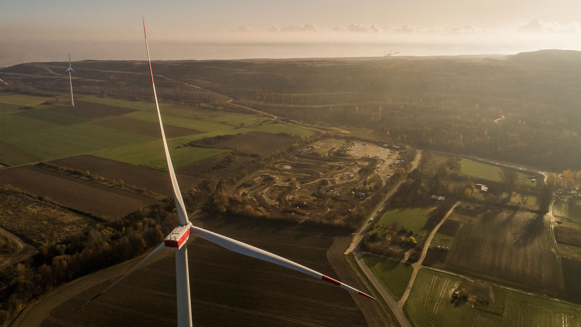 wind turbine overlooking mining operation