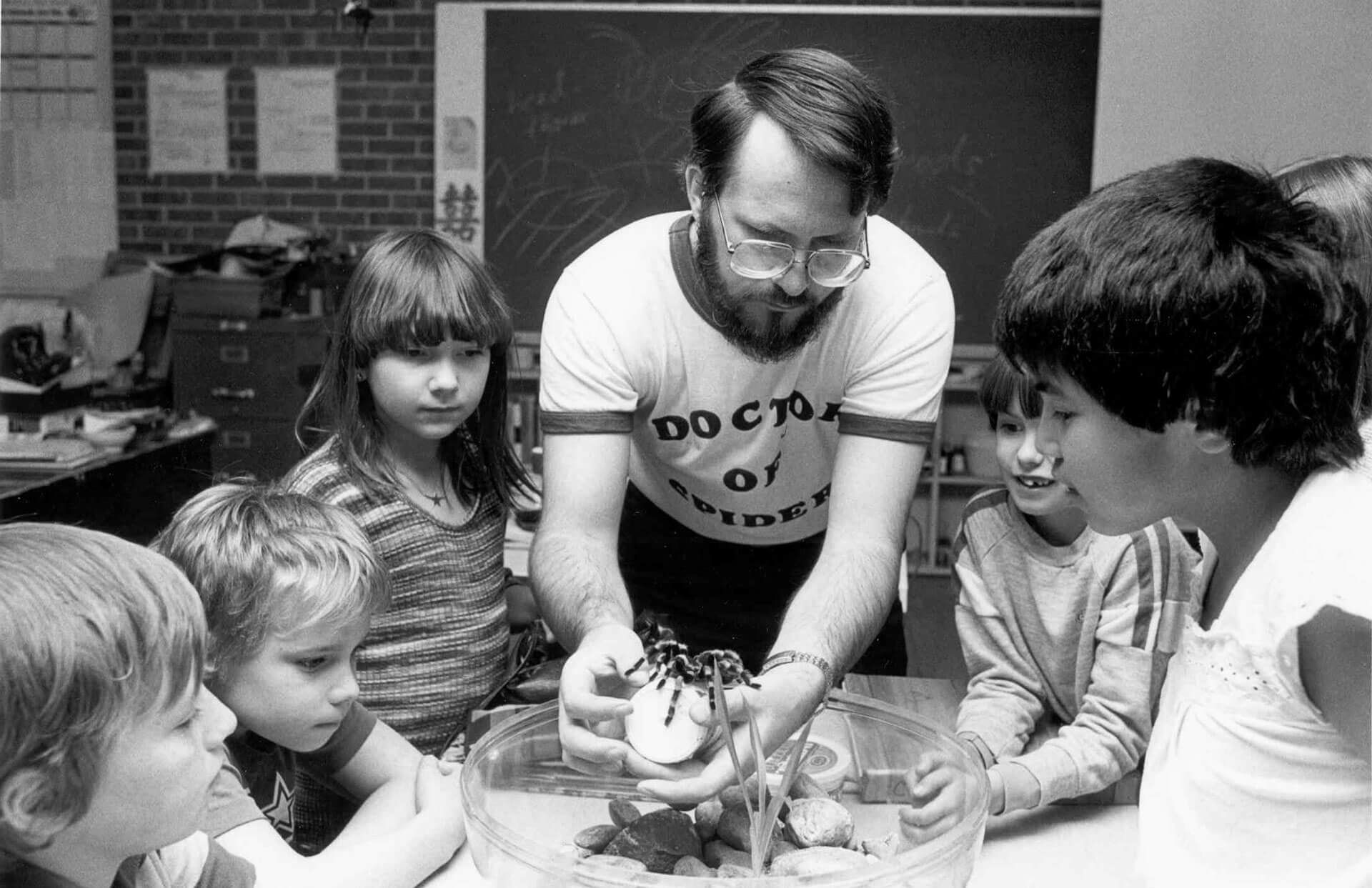 vintage photo of a man showing a tarantula to elementary students