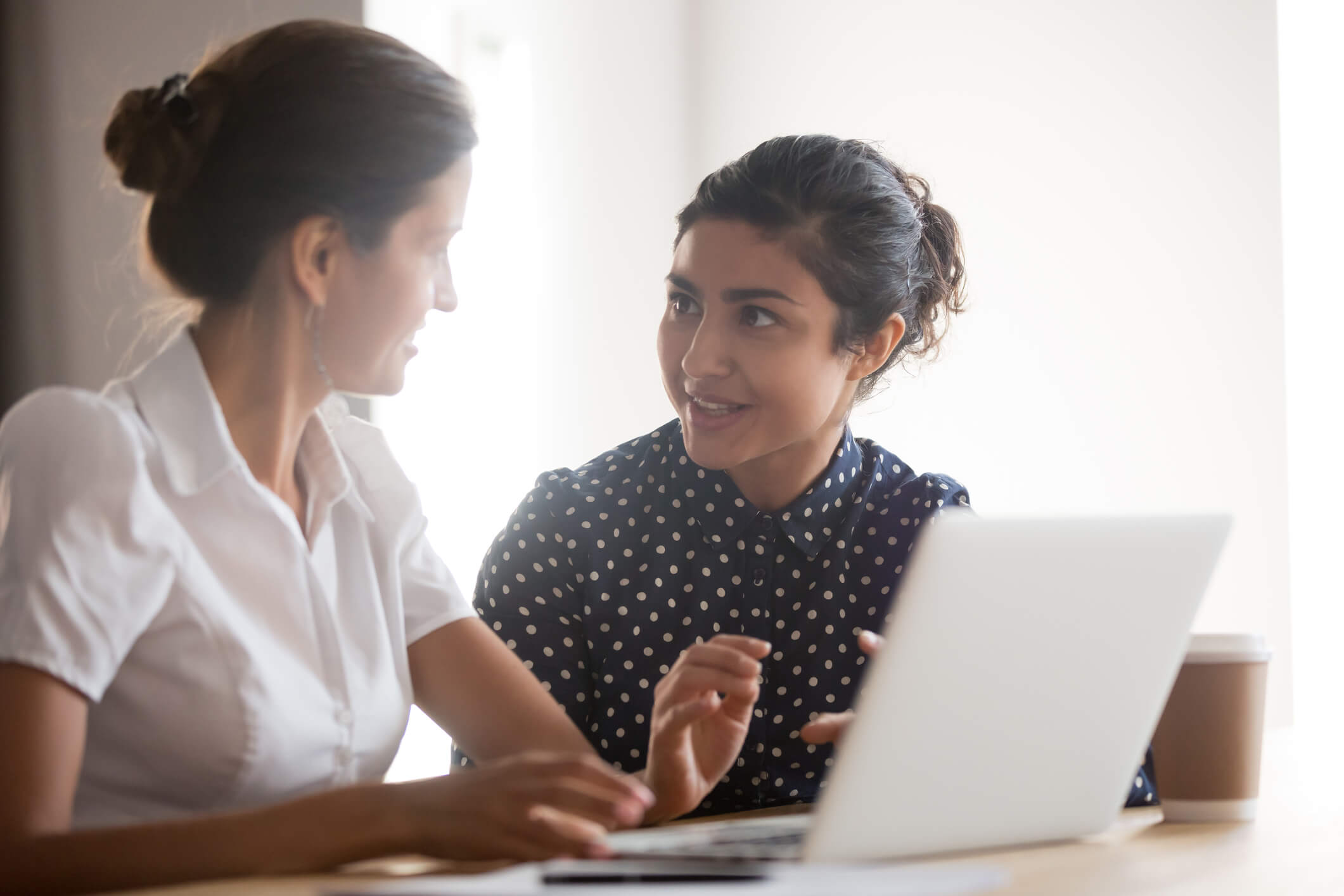 Diverse women team working together on project.