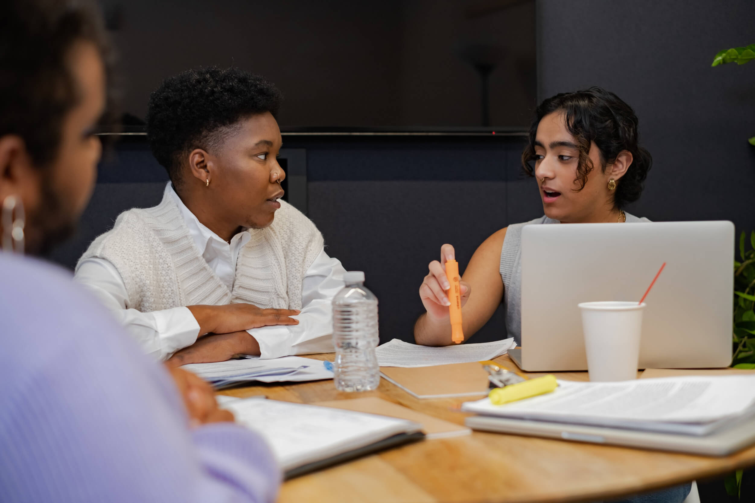 Trans folks discussing something in a meeting.