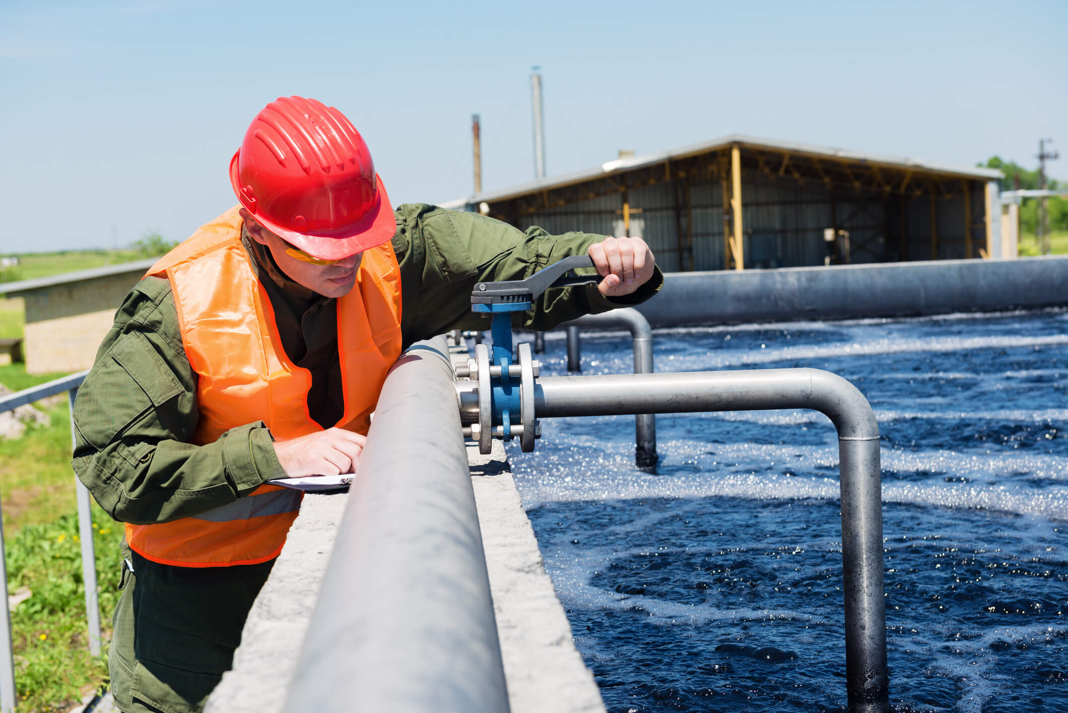 An engineer controlling the quality of water , aerated activated sludge tank at a waste water treatment plant