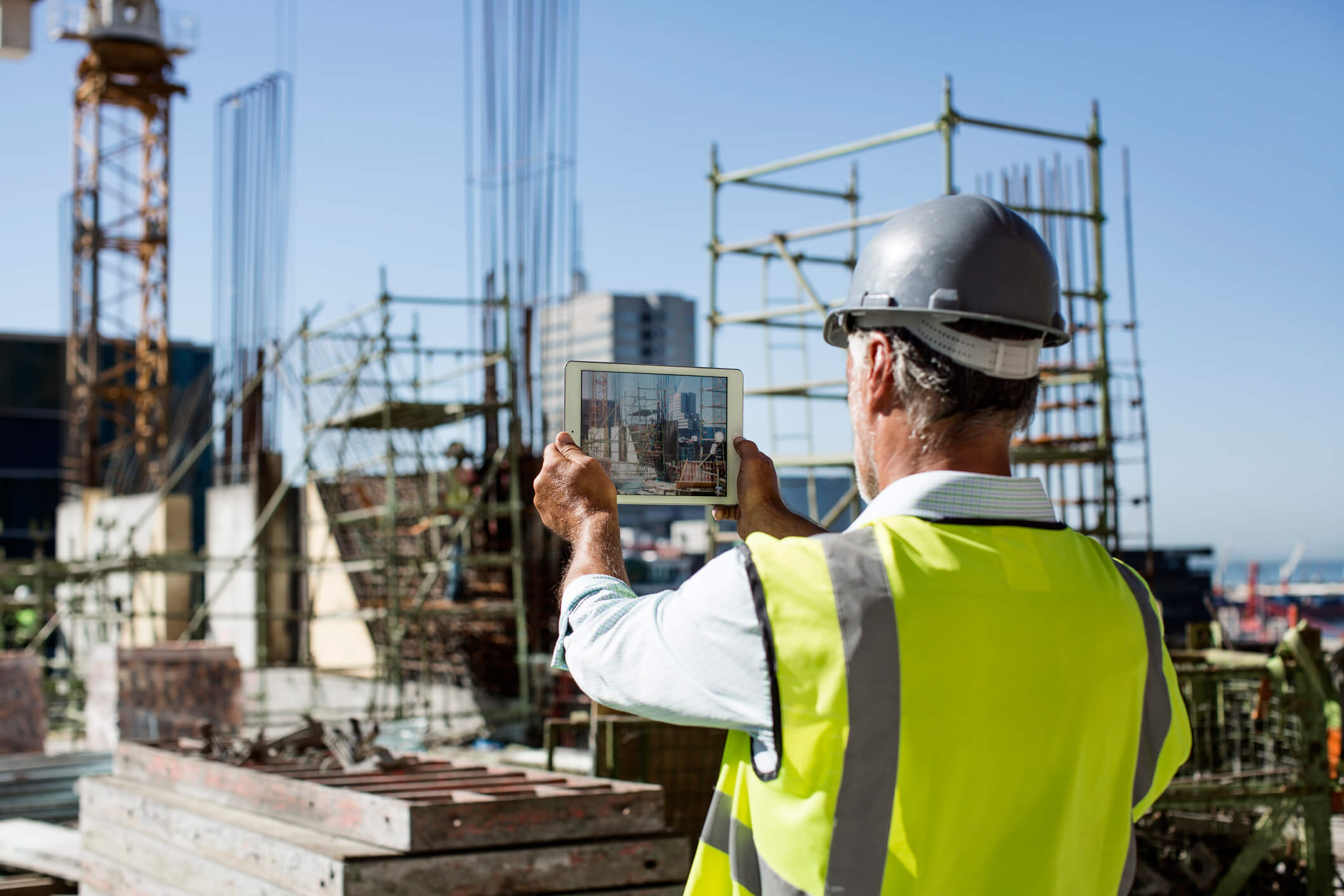 Male architect photographing construction site