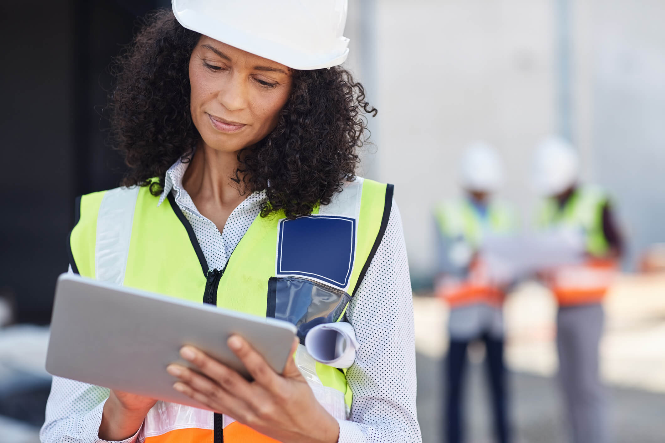 Female building engineer using a tablet on her work site