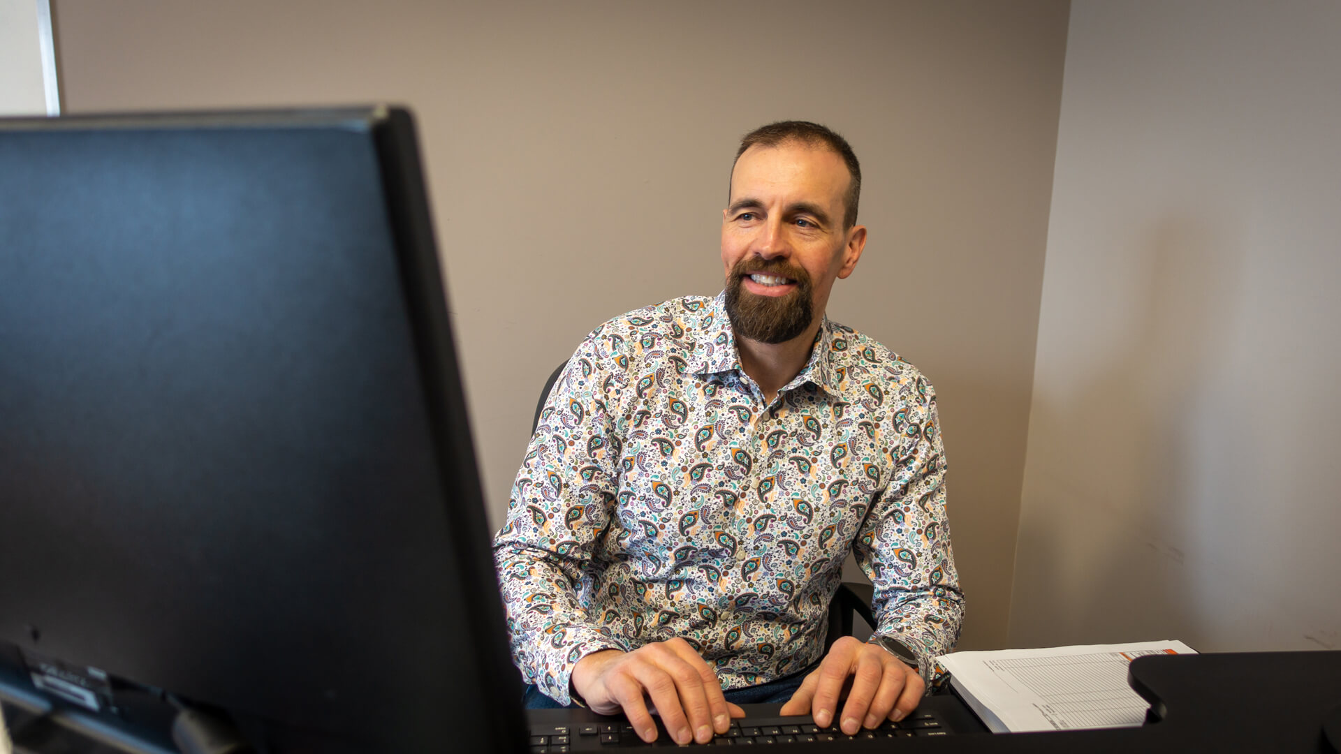 Bob Willows working at a computer station in his office