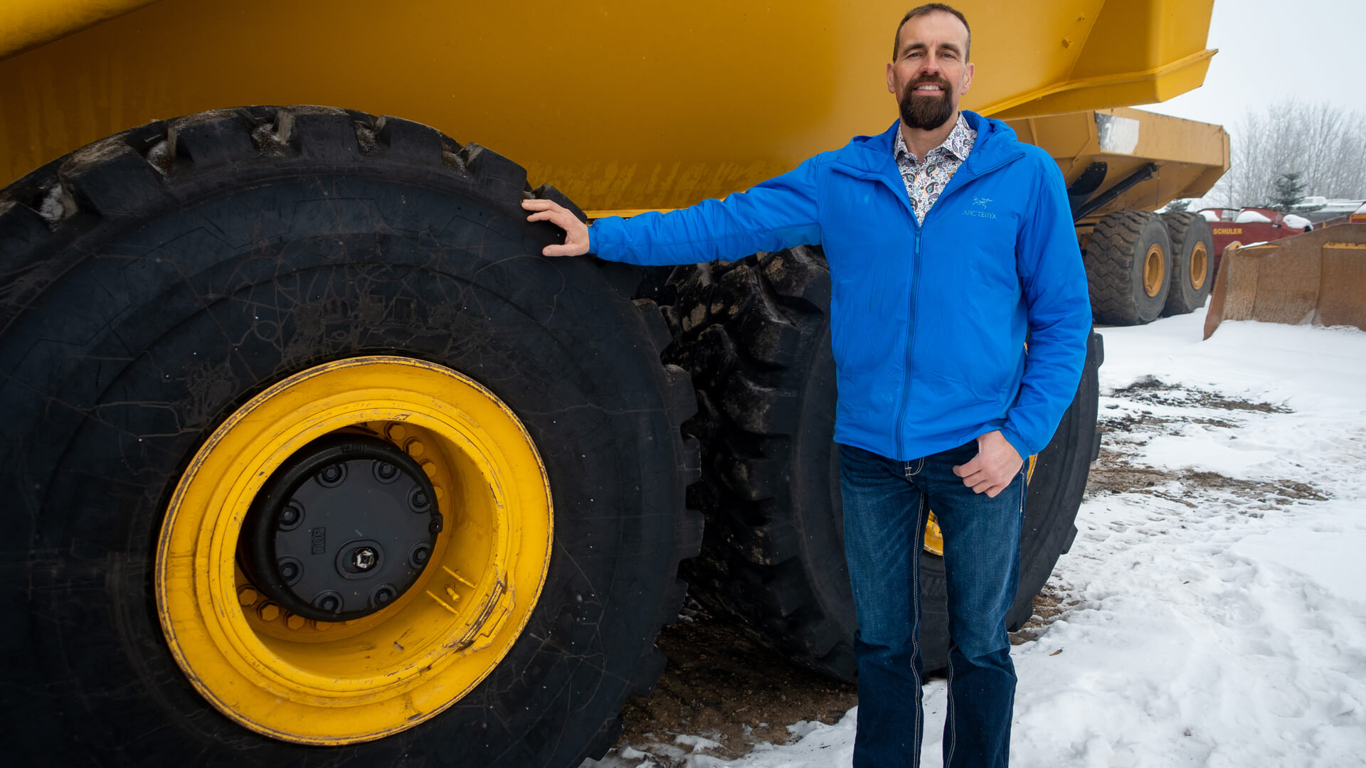 Bob Willows standing in front of heavy equipment