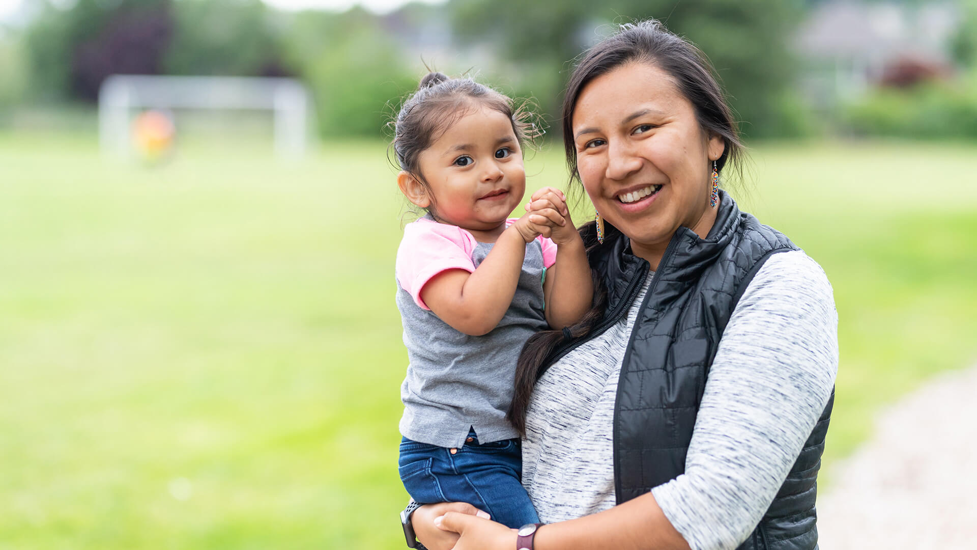 Indigenous mother holds her daughter