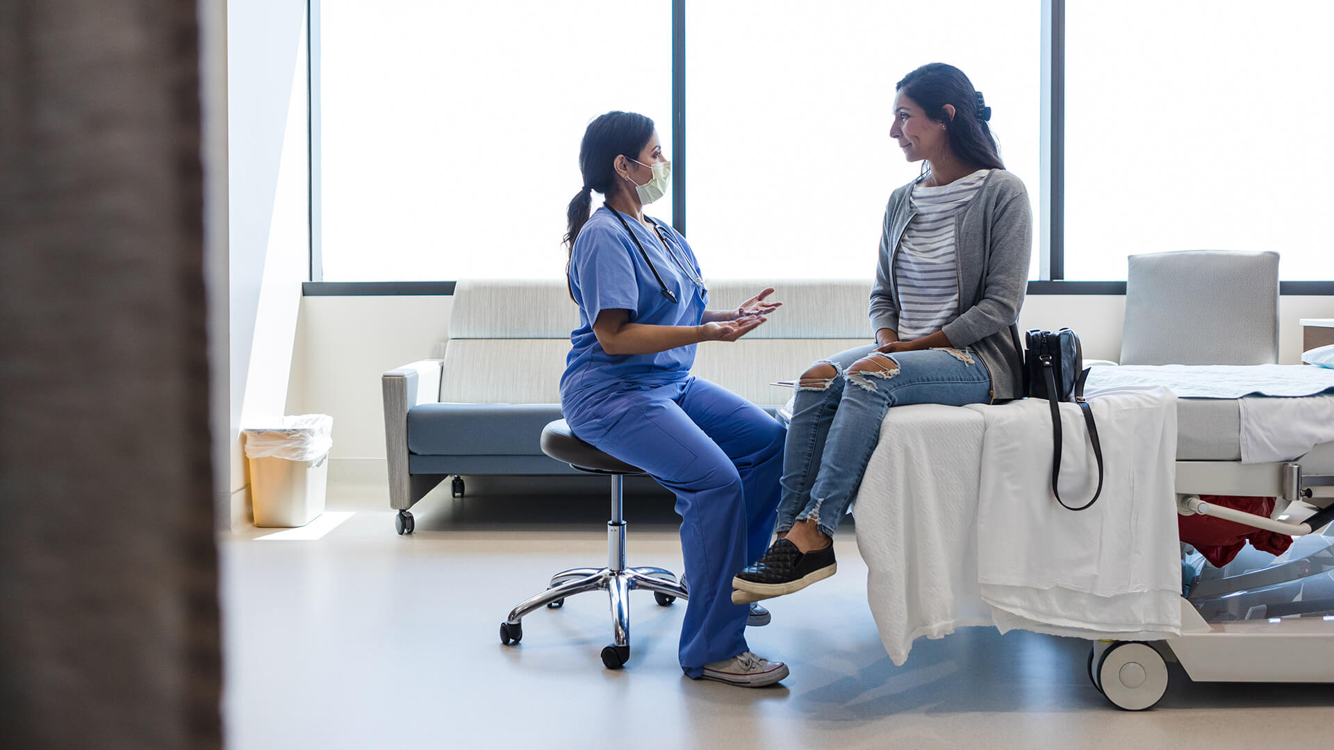 A nurse practitioner treats a patient in hospital