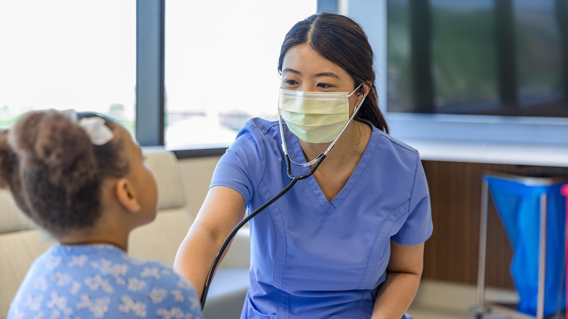 nurse practitioner treats a young patient