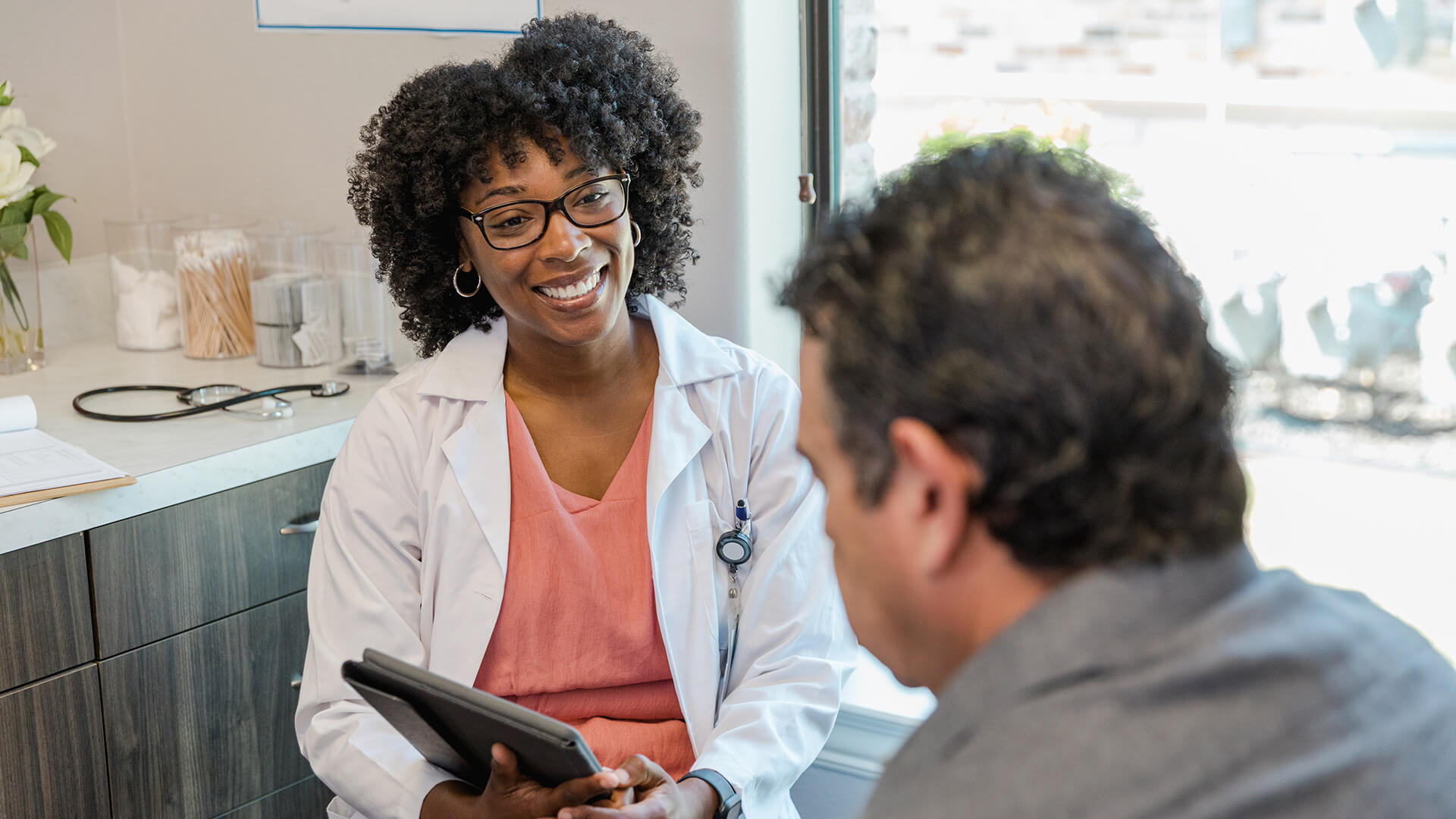 nurse practitioner talks to a patient