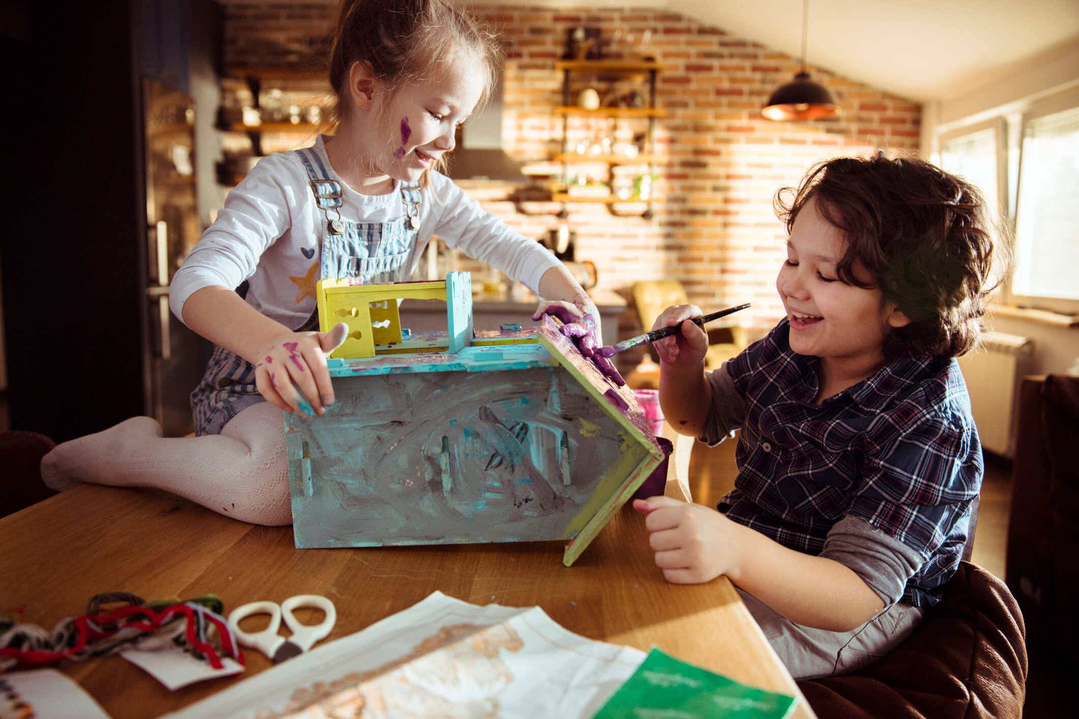 Children painting a doll house