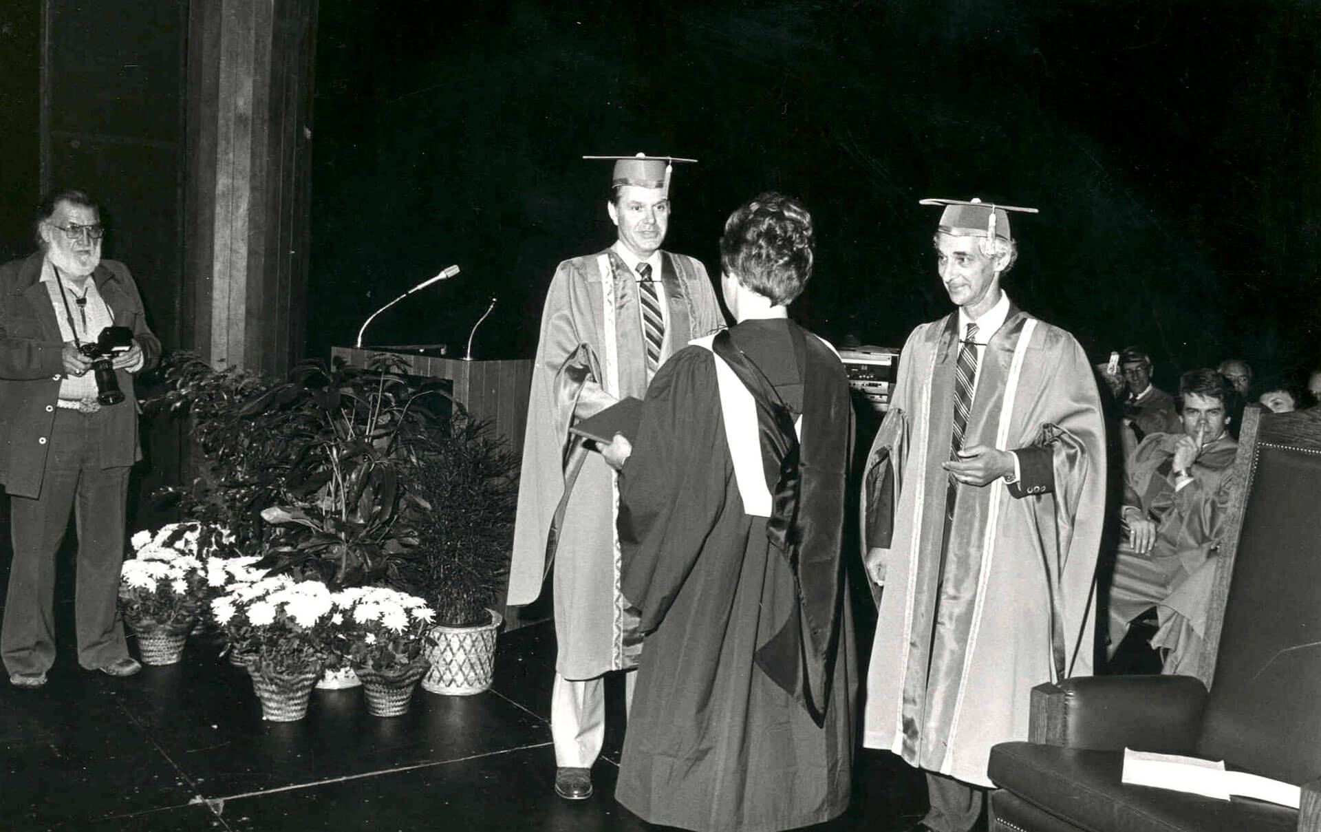 A graduate crosses the stage to receive their degree in this photo