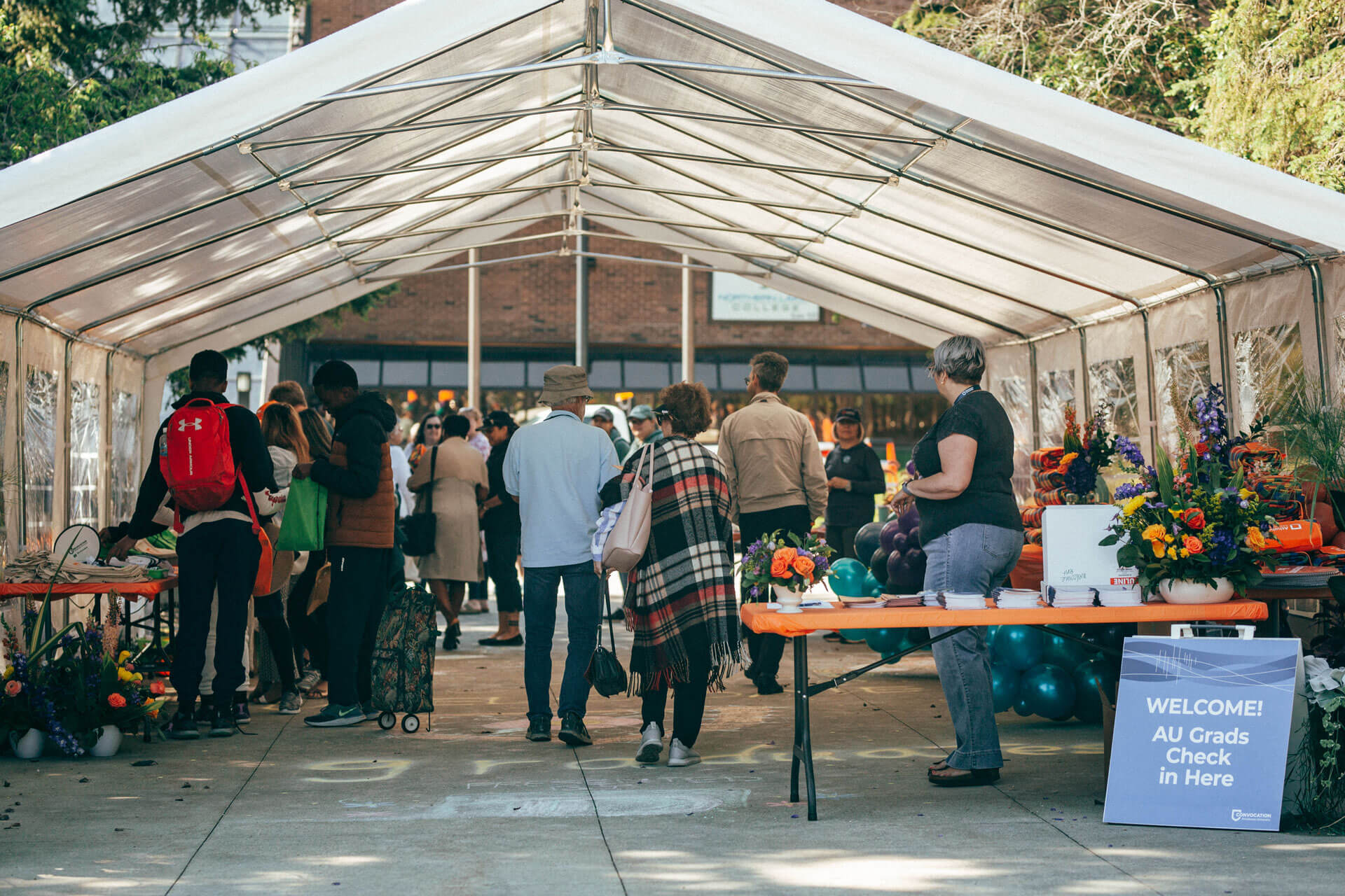 visitors arrive at a tent at Athabasca University’s main campus for homecoming June 18.