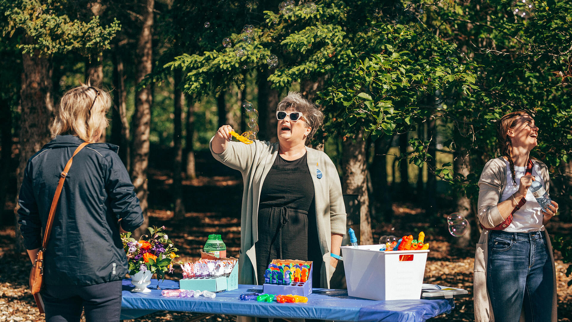 Athabasca University staffers blow bubbles for children at Athabasca University’s main campus for homecoming June 18.