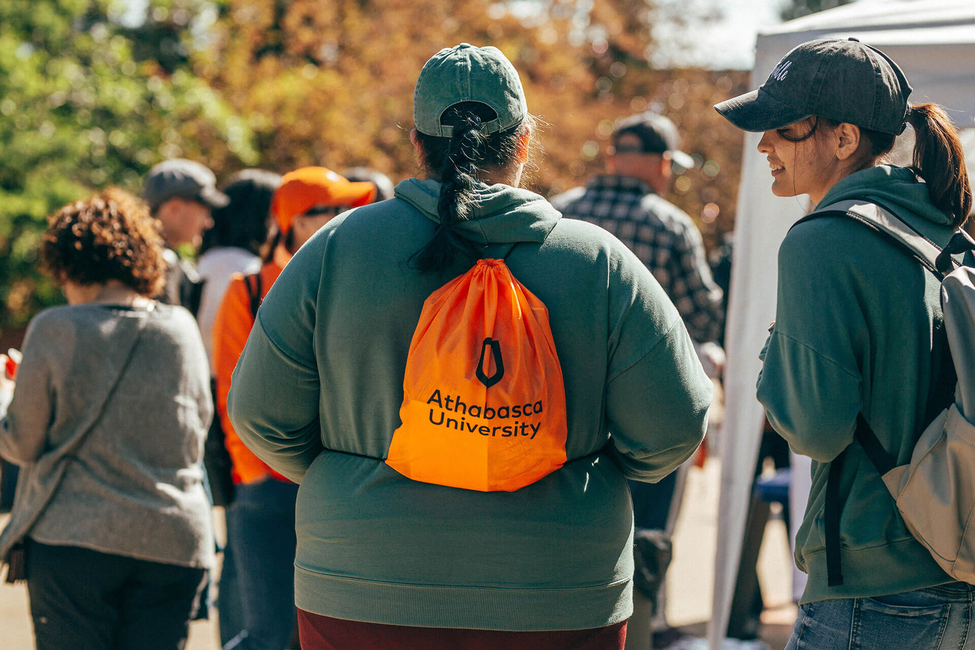 A grad shows off new AU swag at Athabasca University’s main campus for homecoming June 18.