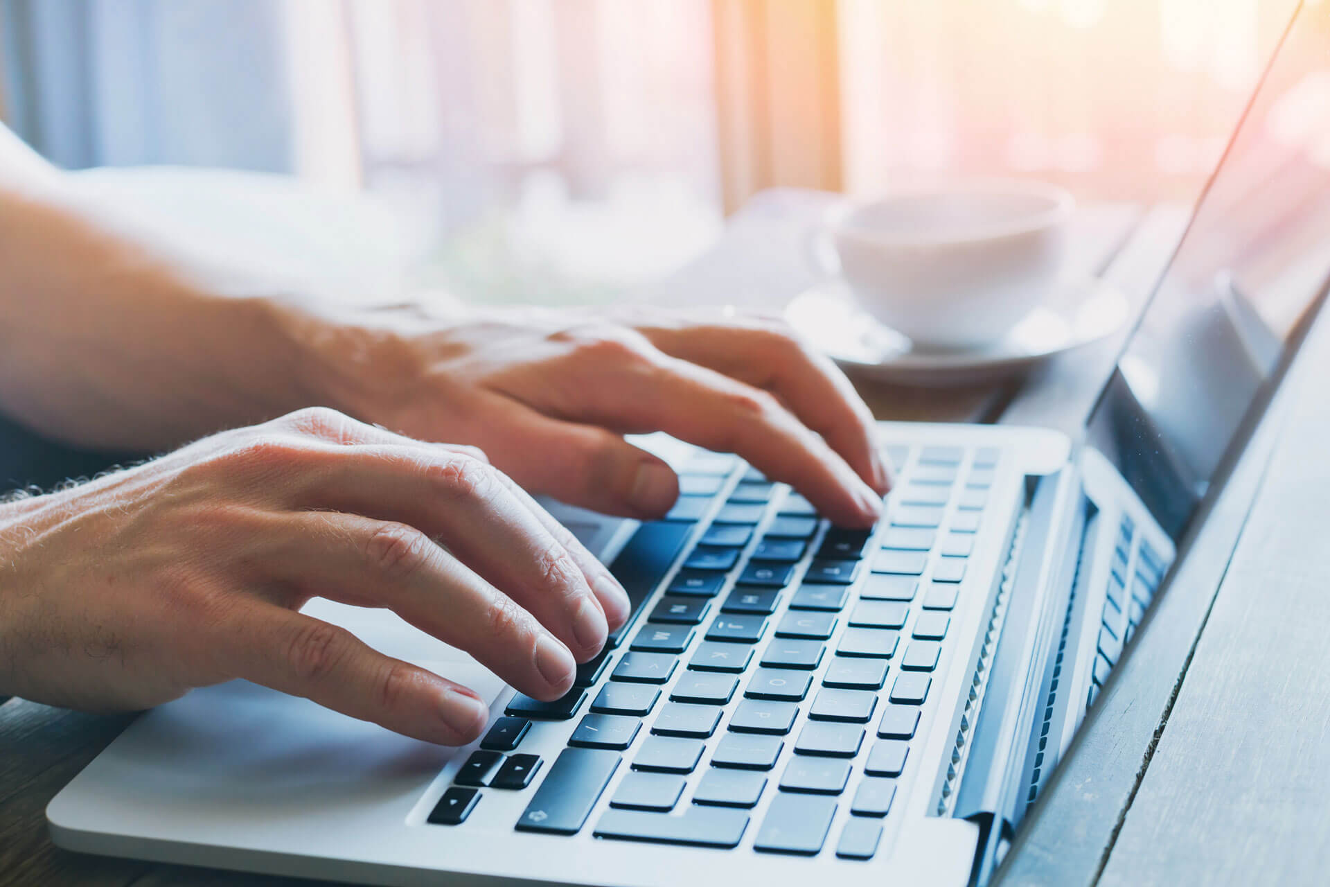 photo of someone's fingers typing on a laptop