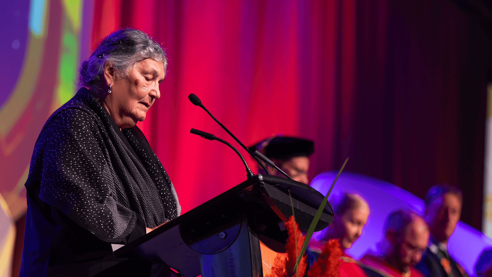 close up shot of Elder Maria Campbell at the podium