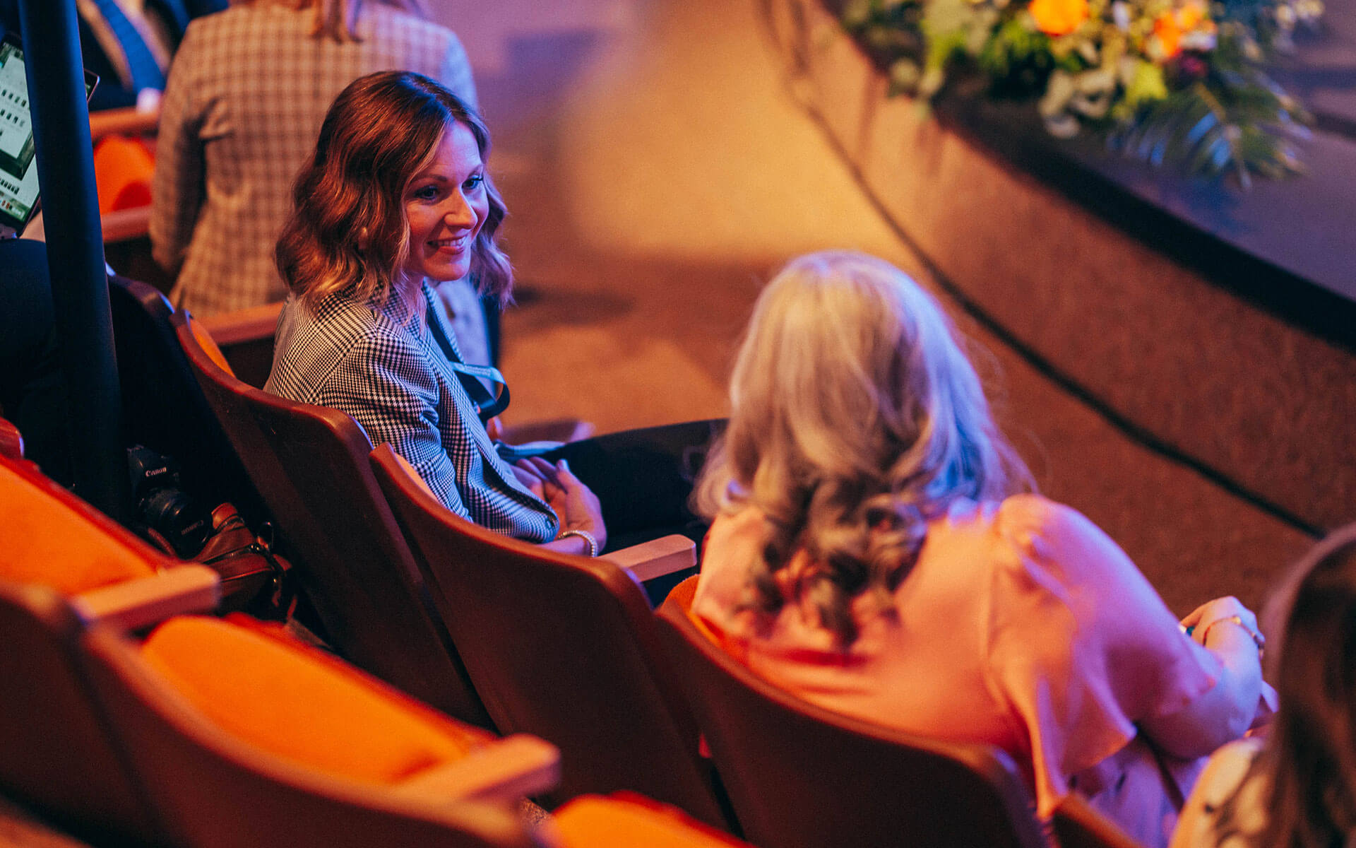 Audience members chat before the start of the installation of Dr. Alex Clark.