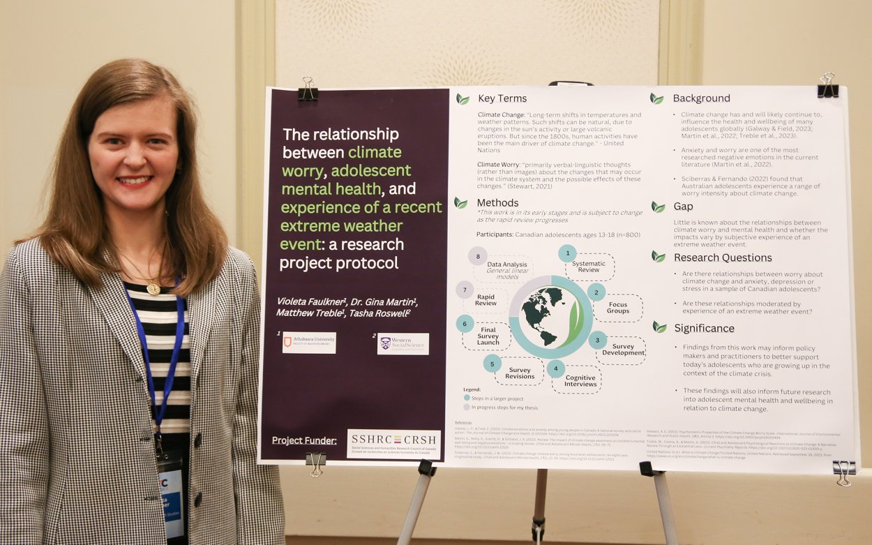 Violeta Faulkner (MHS) standing with her poster on "The Relationship between Climate Worry, Adolescent Mental Health, And Experience Of A Recent Extreme Weather Event: A Research Study Protocol"