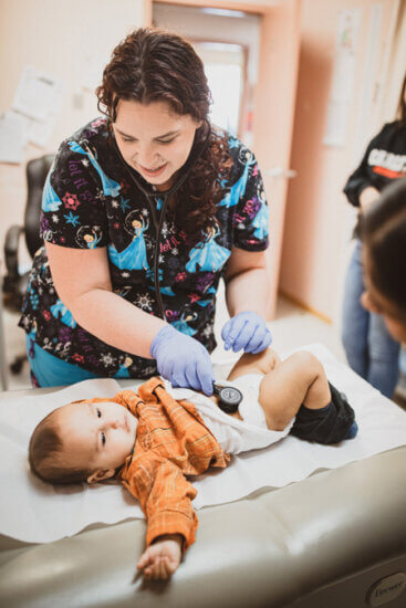 nurse treats an infant