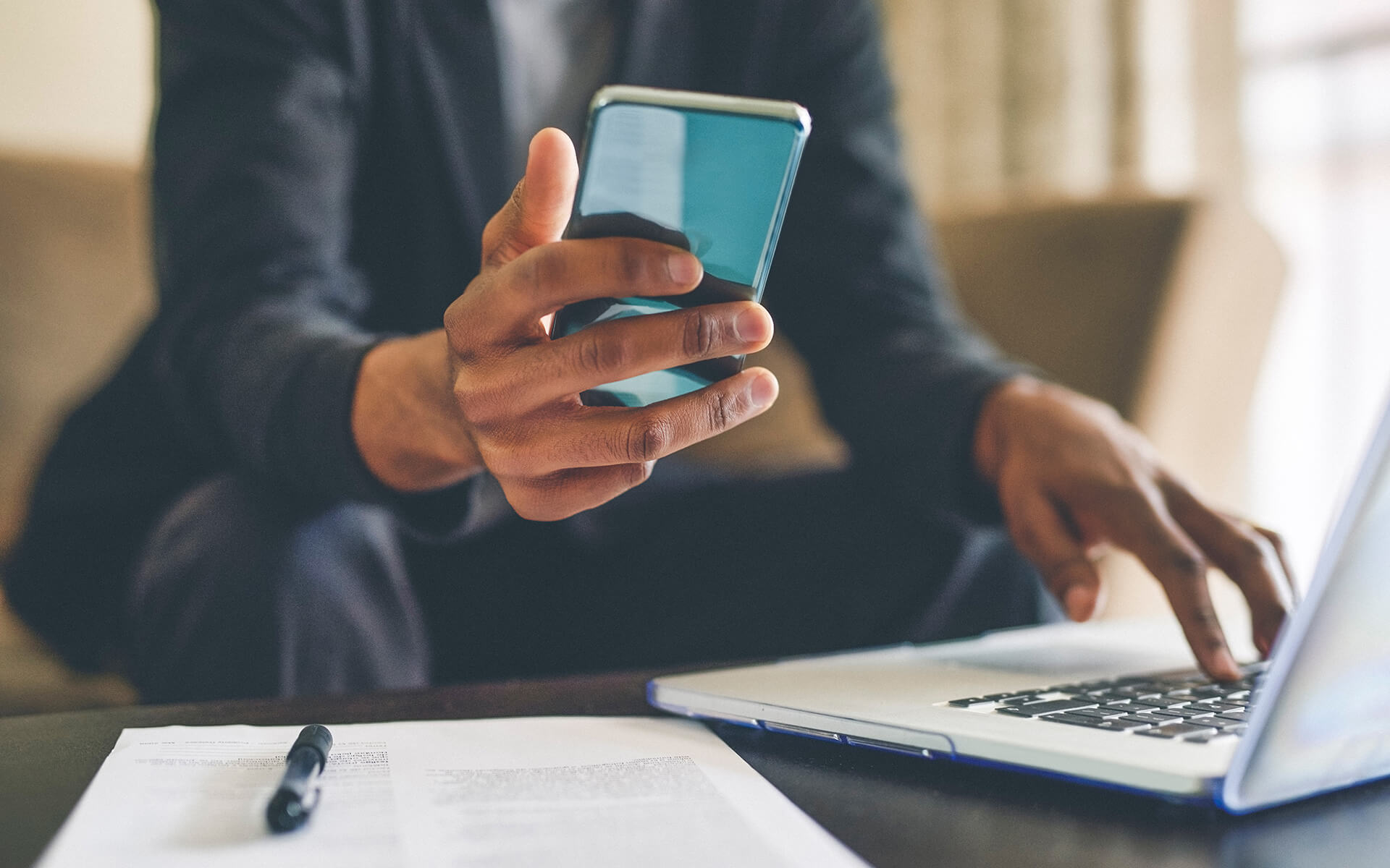 person using cellphone and laptop at the same time - digital addiction at work