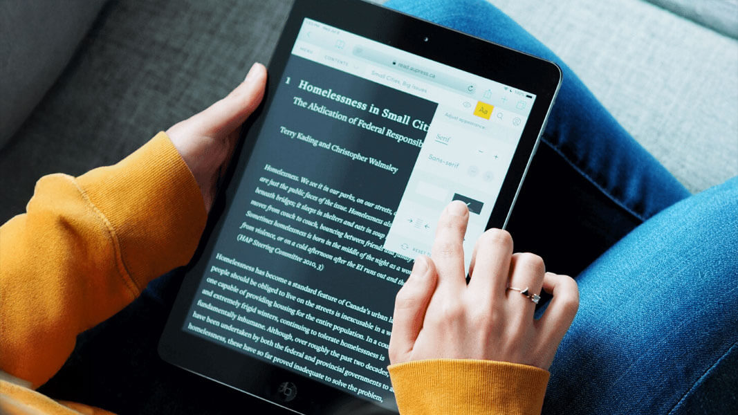 person using a tablet to read open access material