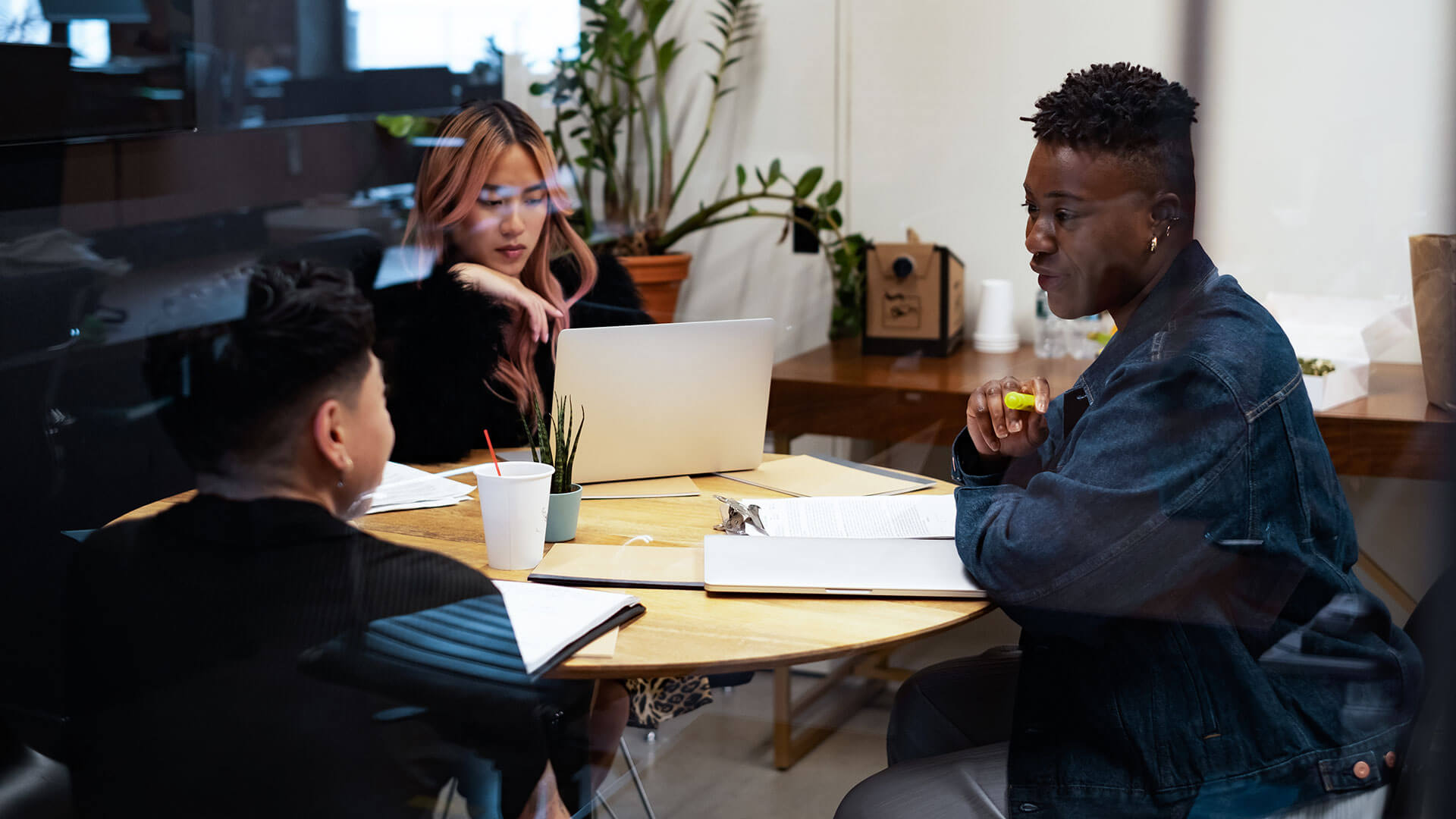 a group of gender-diverse people meet at a table