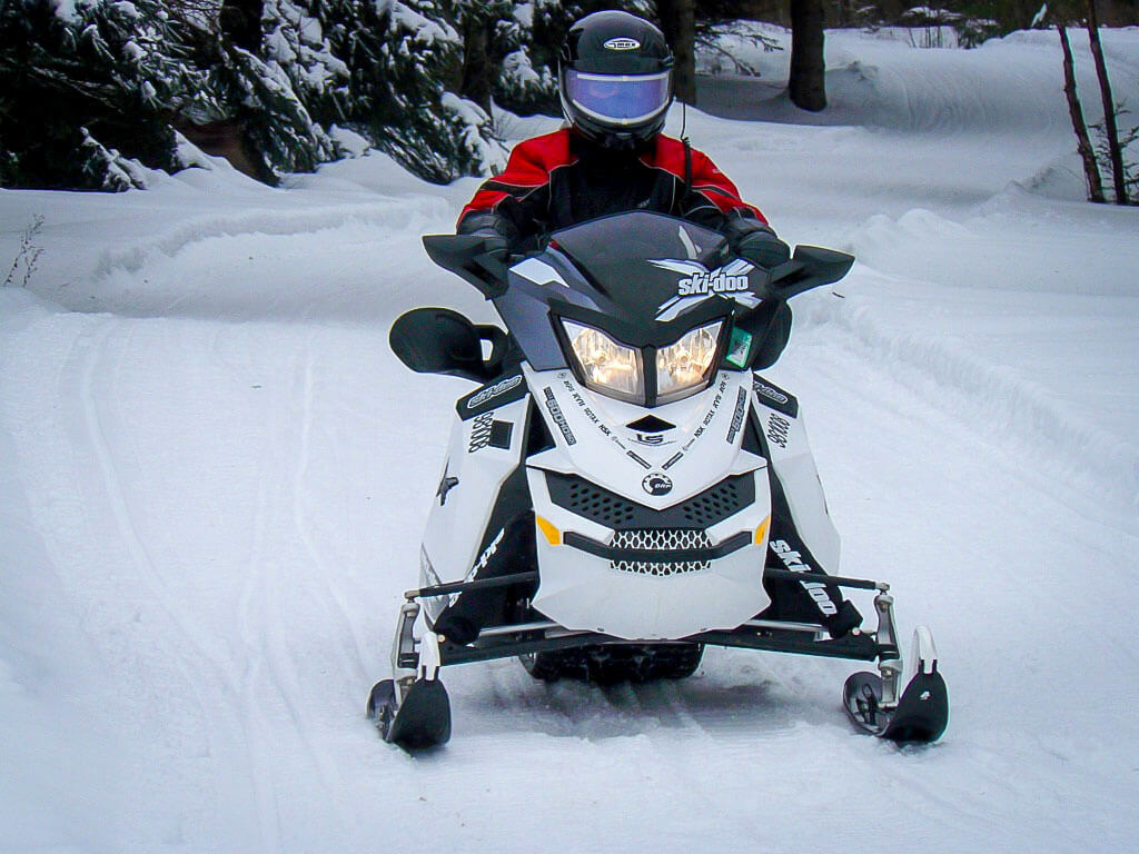 Snowmobiling through the countryside in rural Ontario.