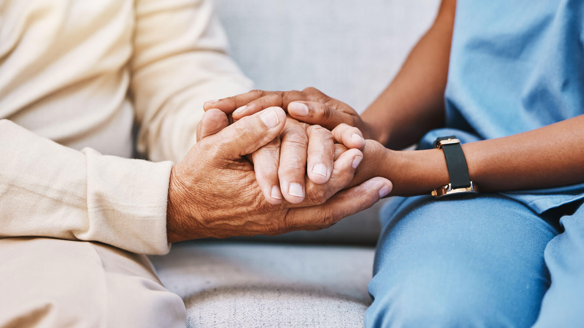 close up of an internationally educated nurse's hands holding a patient